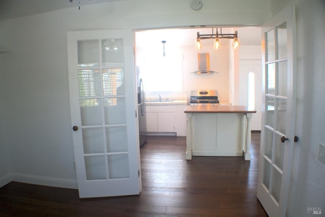 224 Walnut St, Suisun City, CA 94585 - kitchen with a sink, wall chimney range hood, dark wood-style flooring, light countertops, and white cabinets