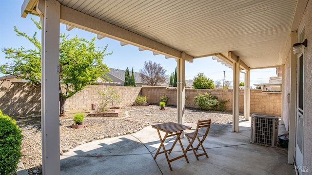 view of patio / terrace with central air condition unit and a fenced backyard