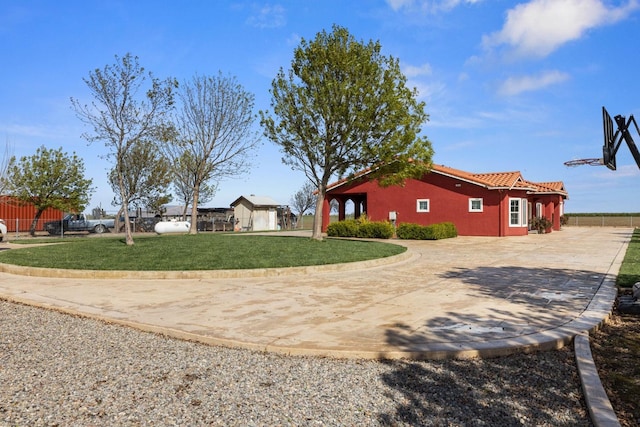 19810 S Spruce Rd, Los Banos, CA 93635 - view of side of property with a tile roof and curved driveway