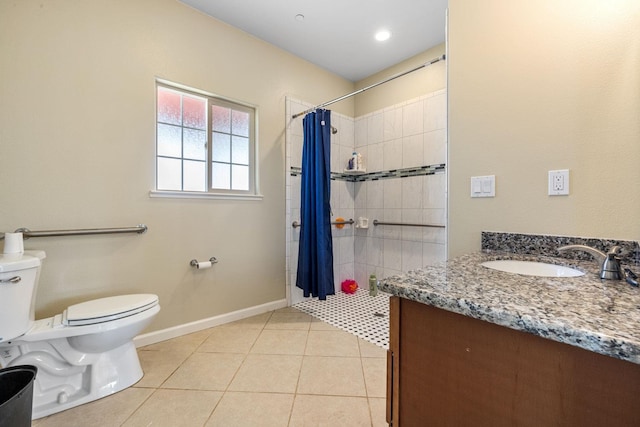 19810 S Spruce Rd, Los Banos, CA 93635 - bathroom with toilet, vanity, a tile shower, tile patterned floors, and baseboards