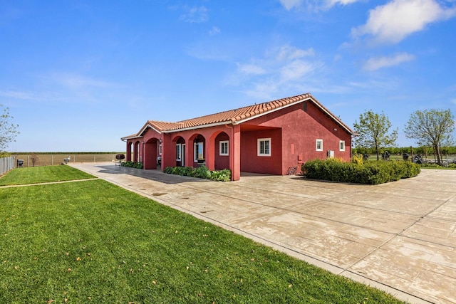 19810 S Spruce Rd, Los Banos, CA 93635 - view of side of home featuring a tile roof, stucco siding, and concrete driveway