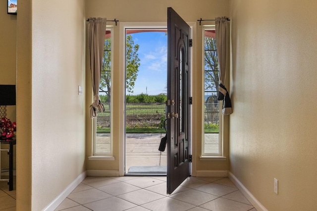 19810 S Spruce Rd, Los Banos, CA 93635 - entrance foyer with baseboards, light tile patterned floors, and a textured wall
