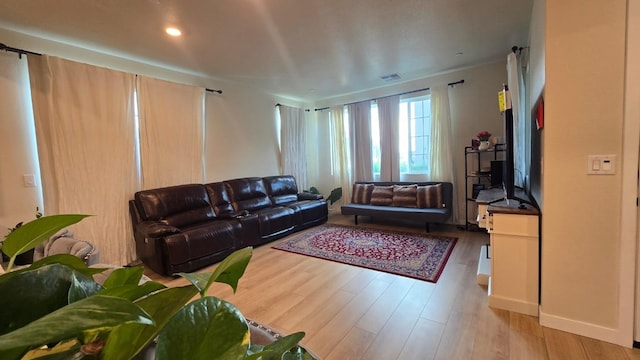 living room with visible vents and wood finished floors