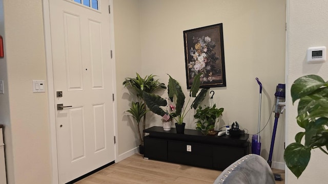 entrance foyer with baseboards and light wood-style floors