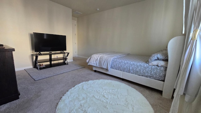 carpeted bedroom featuring baseboards and visible vents