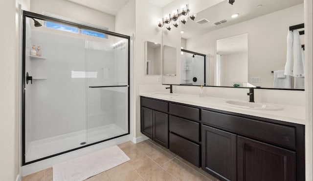 bathroom with visible vents, a sink, a stall shower, and tile patterned flooring