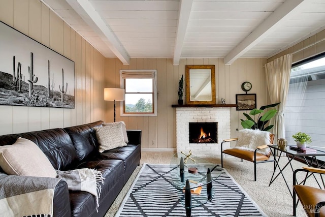 living room featuring light carpet, beamed ceiling, and a fireplace