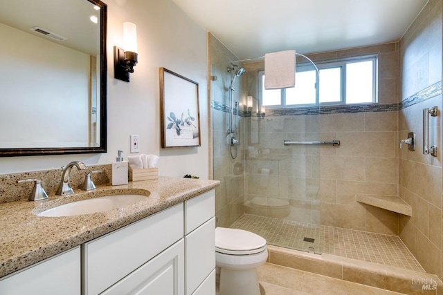 bathroom featuring a shower stall, visible vents, toilet, and vanity