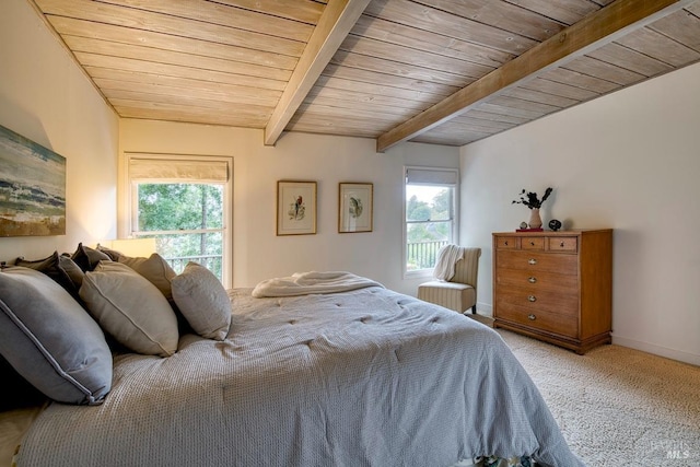 bedroom with carpet floors, baseboards, beamed ceiling, and wood ceiling