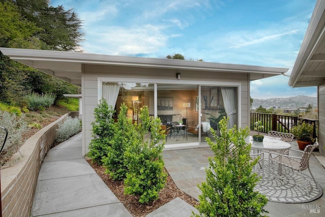rear view of property with a patio area and outdoor dining space