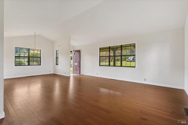 8401 Brandywine Dr, Ukiah, CA 95482 - unfurnished living room with dark wood finished floors, vaulted ceiling, baseboards, and plenty of natural light