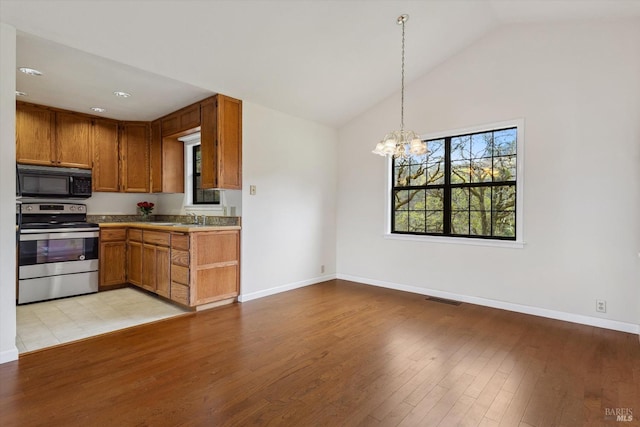 8401 Brandywine Dr, Ukiah, CA 95482 - kitchen featuring brown cabinets, black microwave, visible vents, a chandelier, and stainless steel range with electric cooktop