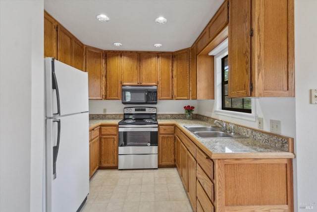 8401 Brandywine Dr, Ukiah, CA 95482 - kitchen featuring stainless steel electric range oven, freestanding refrigerator, brown cabinets, a sink, and black microwave