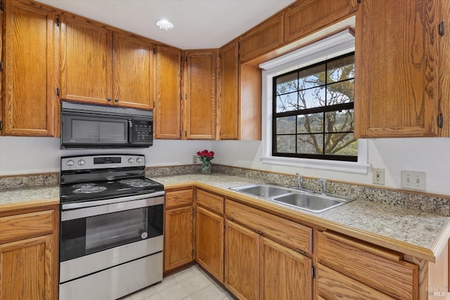 8401 Brandywine Dr, Ukiah, CA 95482 - kitchen featuring stainless steel range with electric stovetop, a sink, brown cabinets, black microwave, and light countertops