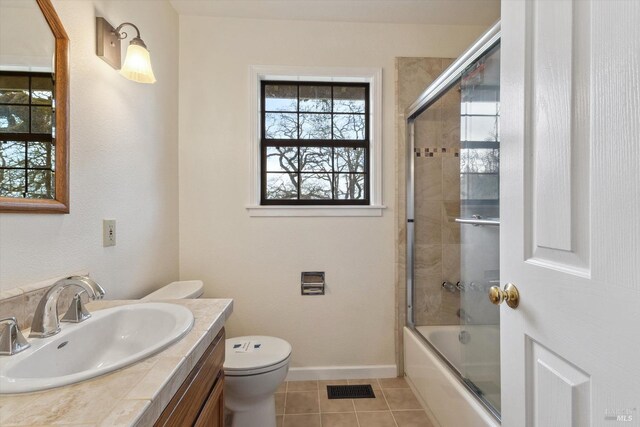 8401 Brandywine Dr, Ukiah, CA 95482 - bathroom featuring vanity, tile patterned floors, toilet, combined bath / shower with glass door, and visible vents