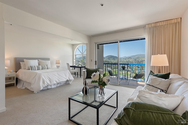 bedroom featuring a mountain view, access to exterior, and carpet floors