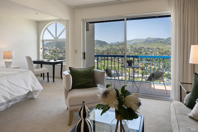 bedroom with a mountain view, access to exterior, and carpet floors