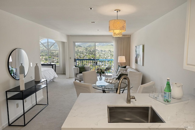 carpeted living area featuring a sink