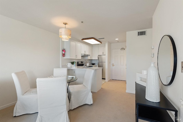 dining room featuring visible vents, baseboards, recessed lighting, and light carpet