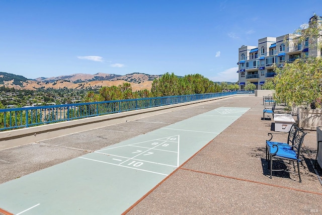 view of community with shuffleboard and a mountain view