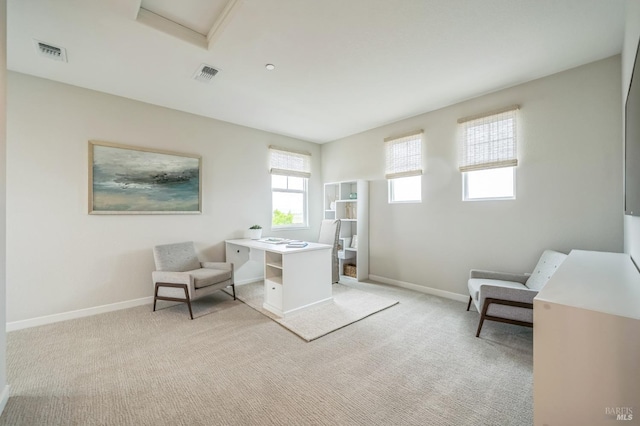 office space with visible vents, attic access, baseboards, and light carpet