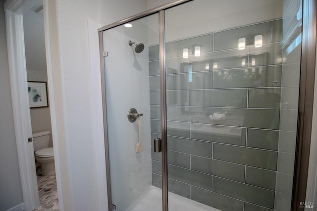 full bath with toilet and a shower stall