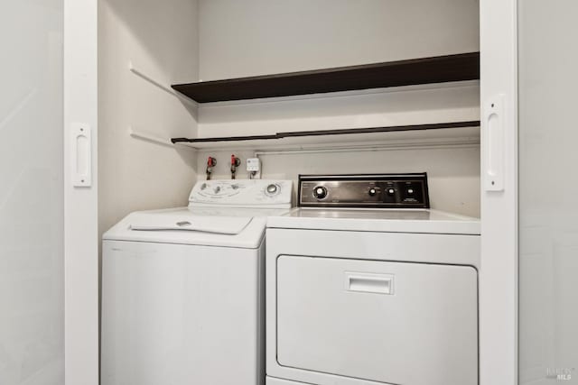 laundry room with separate washer and dryer and laundry area