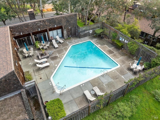pool with fence and a patio