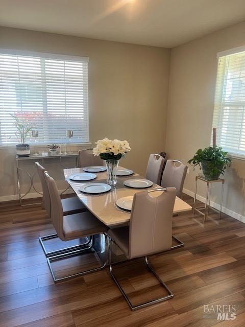 dining area featuring baseboards and wood finished floors
