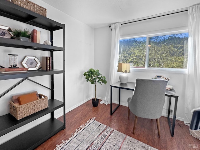 office space featuring baseboards and wood finished floors