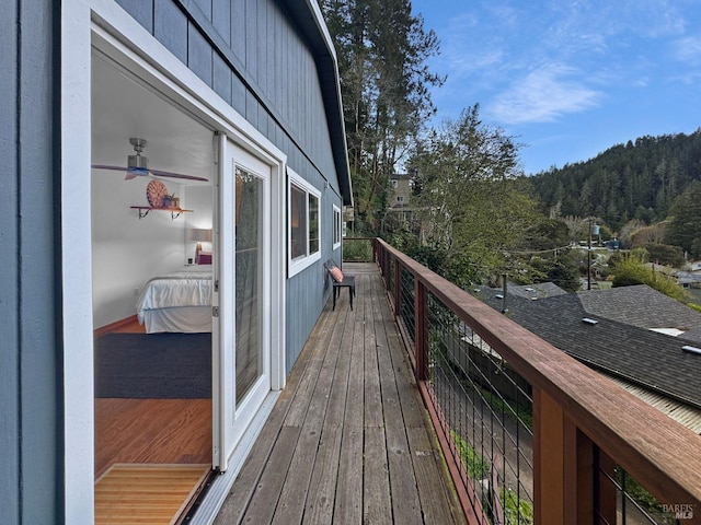 wooden deck featuring a view of trees