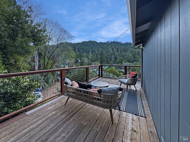 wooden deck featuring a view of trees