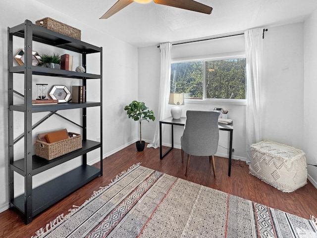 office space with baseboards, ceiling fan, and wood finished floors