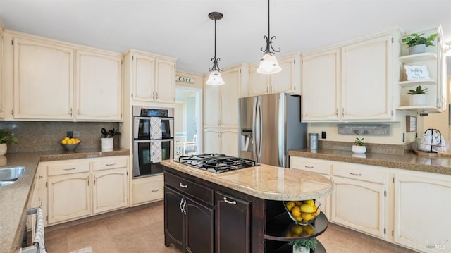 kitchen with open shelves, appliances with stainless steel finishes, and cream cabinets