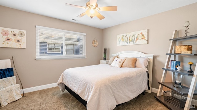 carpeted bedroom with baseboards, a ceiling fan, and visible vents