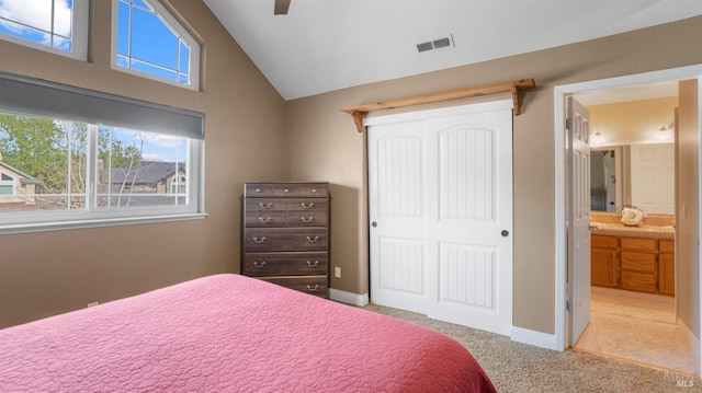 carpeted bedroom featuring a closet, baseboards, ceiling fan, visible vents, and vaulted ceiling