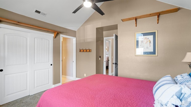 bedroom with a closet, carpet floors, visible vents, ceiling fan, and lofted ceiling
