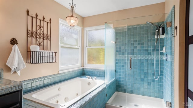 bathroom featuring vanity, plenty of natural light, a jetted tub, and a stall shower