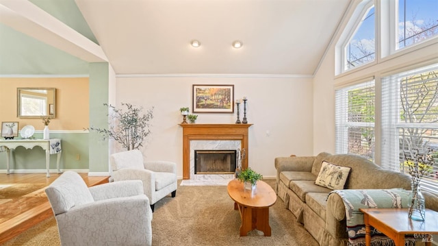 living room with ornamental molding, a premium fireplace, and high vaulted ceiling