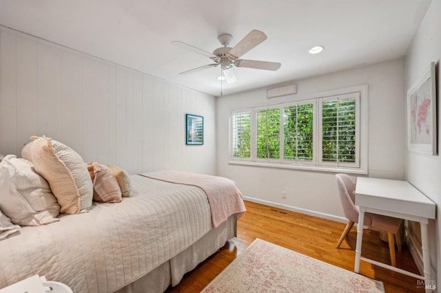 bedroom featuring a ceiling fan, baseboards, and wood finished floors