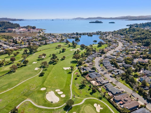 bird's eye view featuring golf course view and a water view