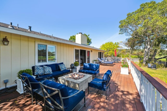 wooden deck with an outdoor living space with a fire pit