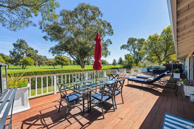 wooden deck featuring outdoor dining area