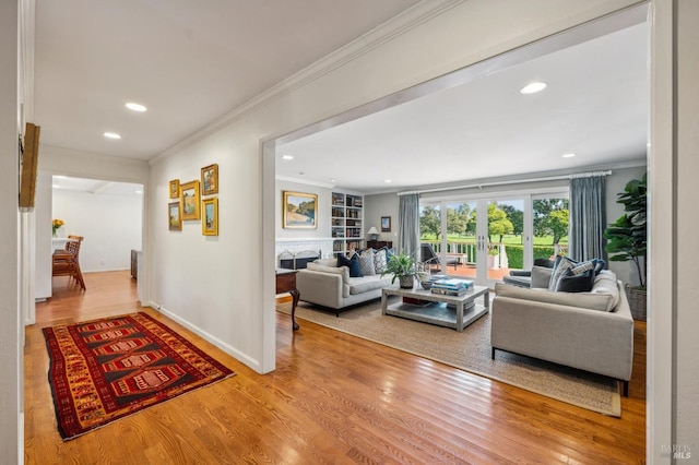 living area featuring recessed lighting, ornamental molding, and wood finished floors