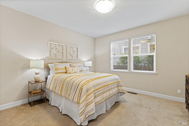 carpeted bedroom featuring baseboards and visible vents