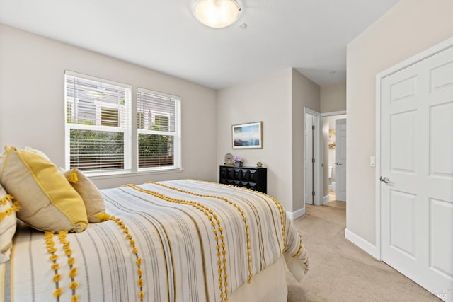 carpeted bedroom featuring baseboards