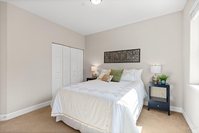 bedroom with a closet, baseboards, and carpet