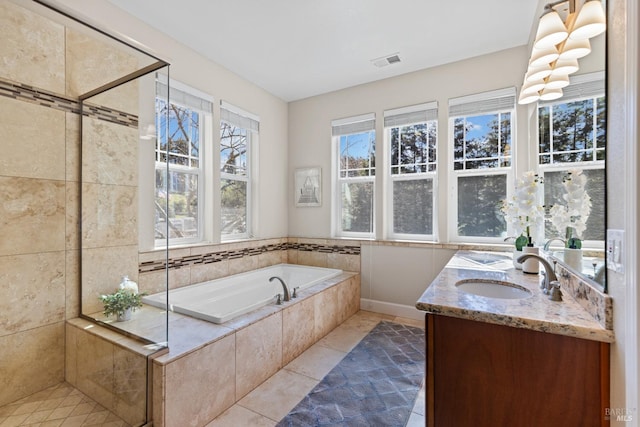 full bathroom with a sink, a wealth of natural light, visible vents, and a bath