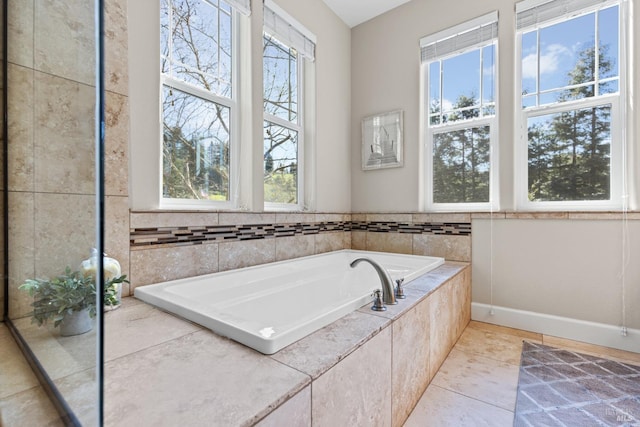 full bath with a bath and tile patterned flooring