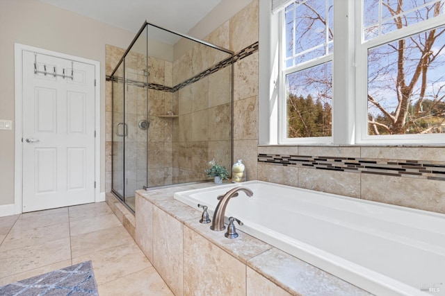 bathroom with a bath, tile patterned floors, and a shower stall